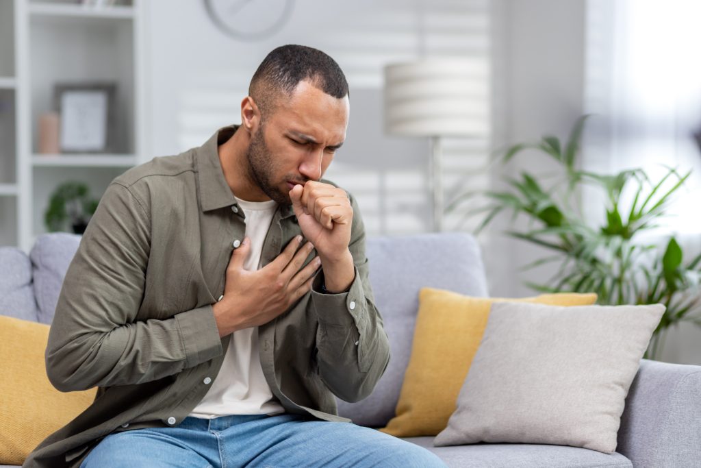 Man holding chest in pain