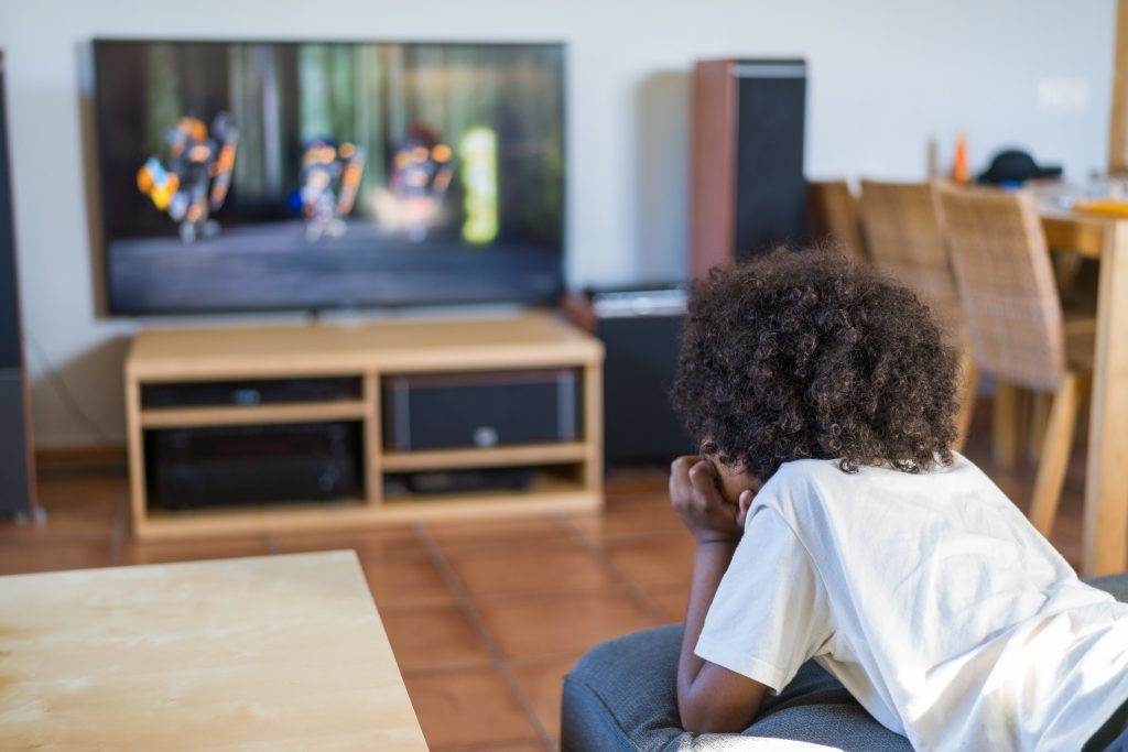 Young boy watching violent screentime
