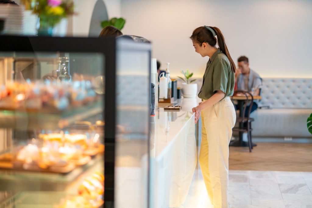 Woman standing in bakery line- stock image