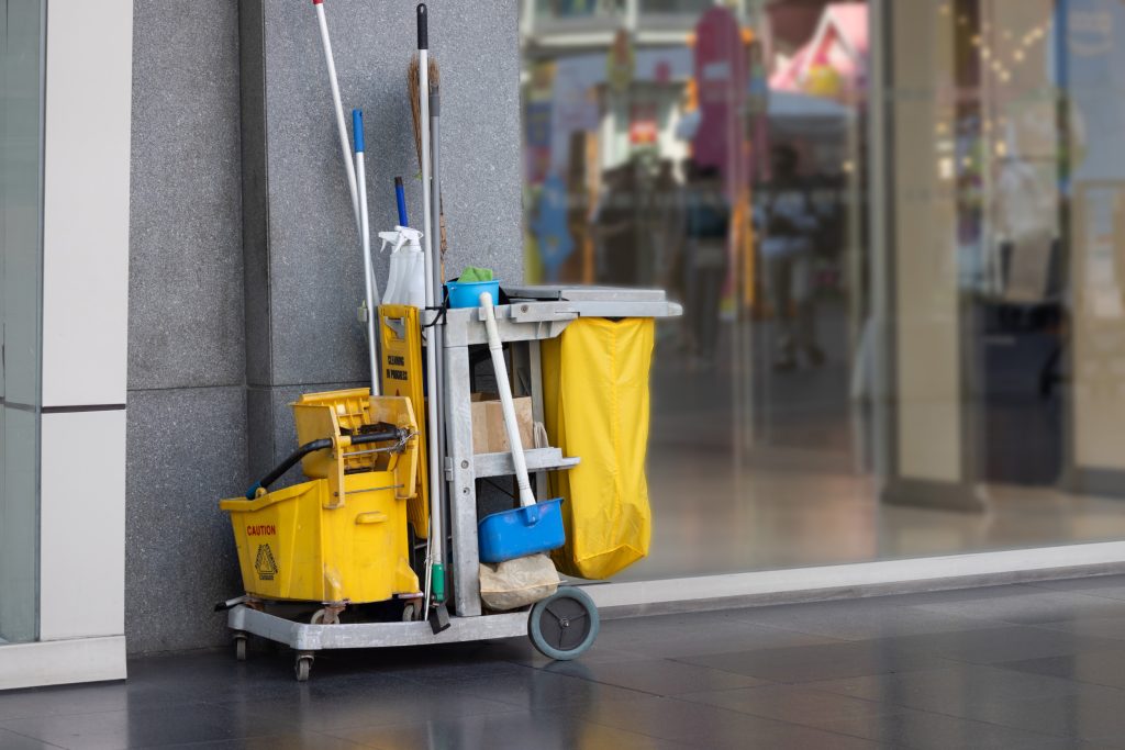 A yellow cleaning cart with a yellow