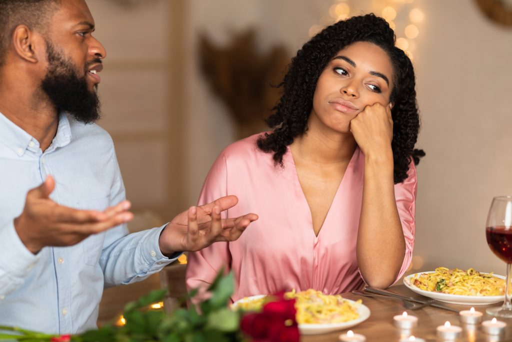Unhappy couple at dinner - stock image