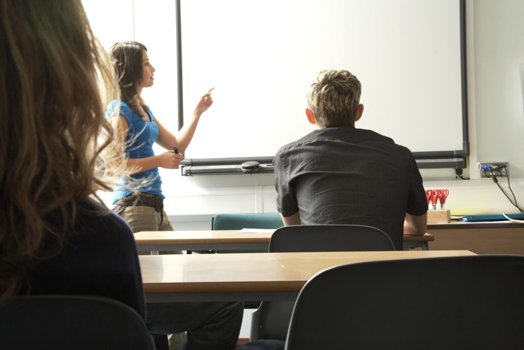 Female student giving presentation in class