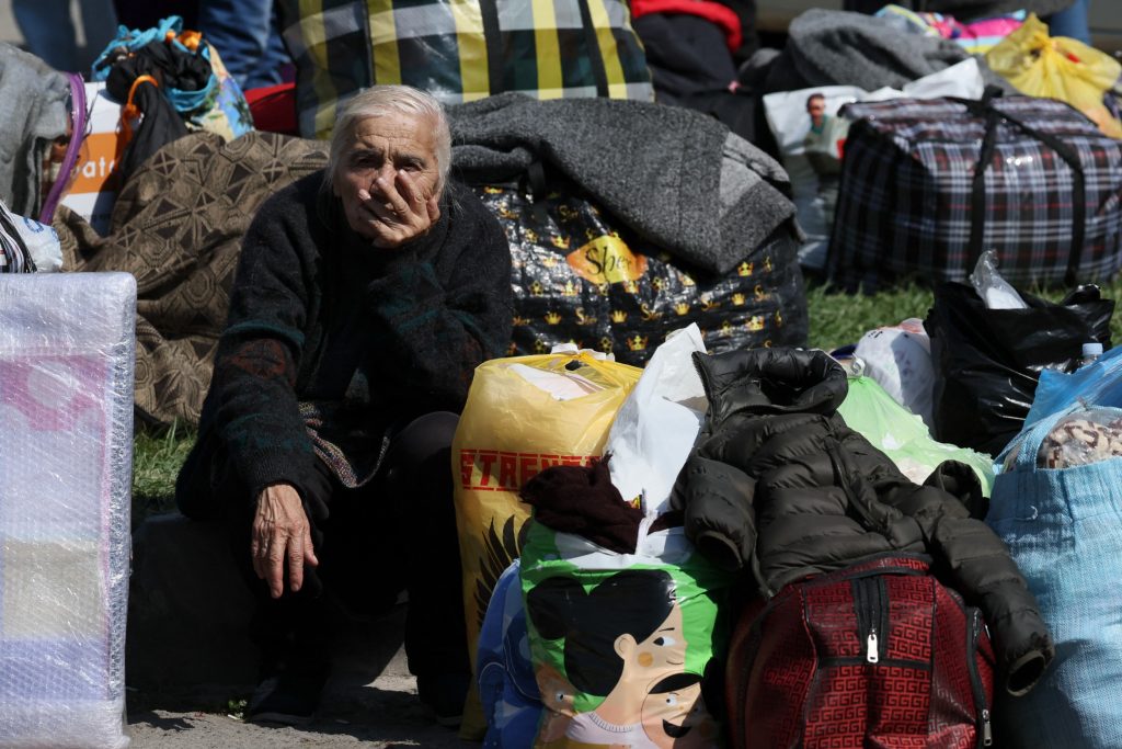 An elderly women sits
