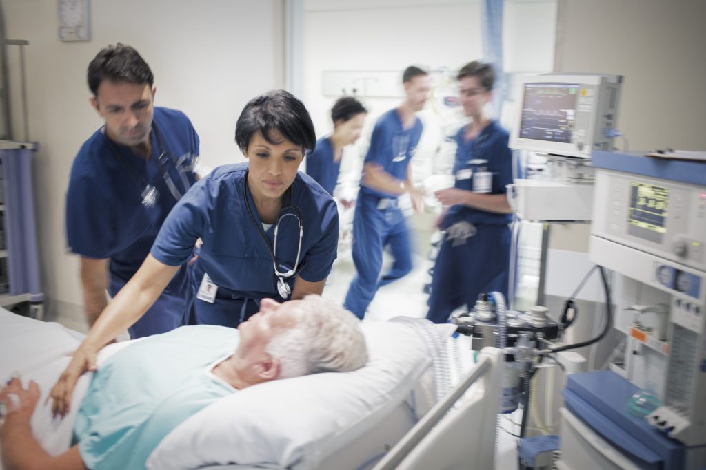A patient lies in a hospital bed