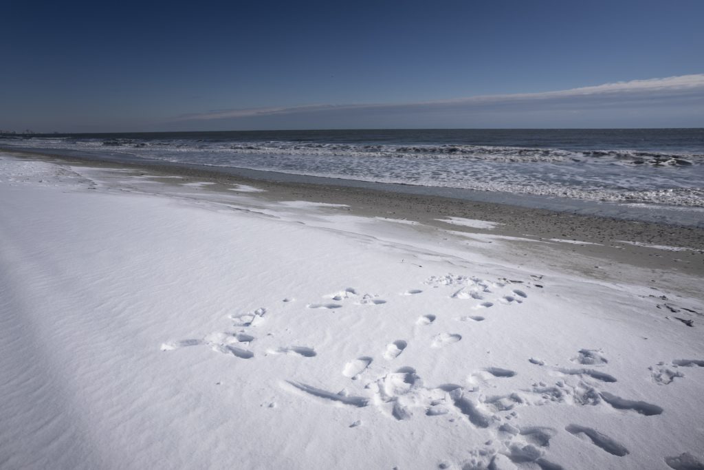 Video shows snow-covered beach rare