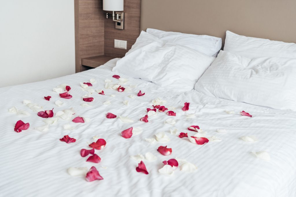 bed covered in rose petals