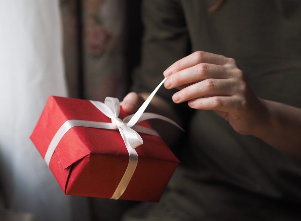Woman Unties Red Gift